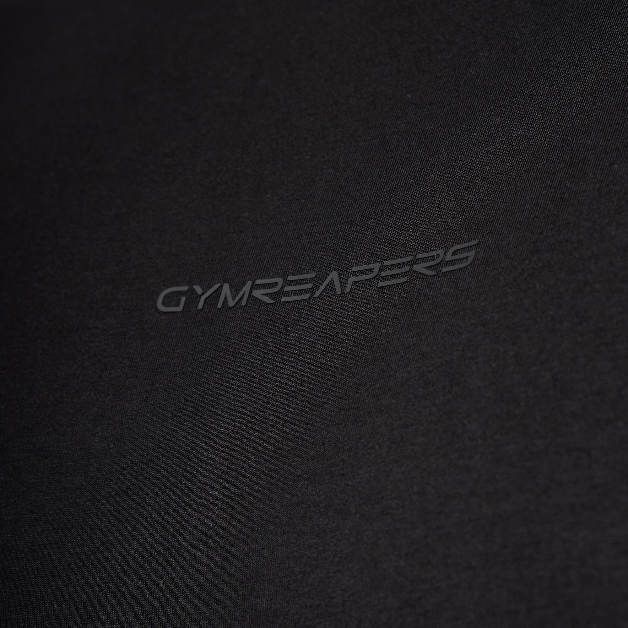 close up detail shot of logo on black axis box tee