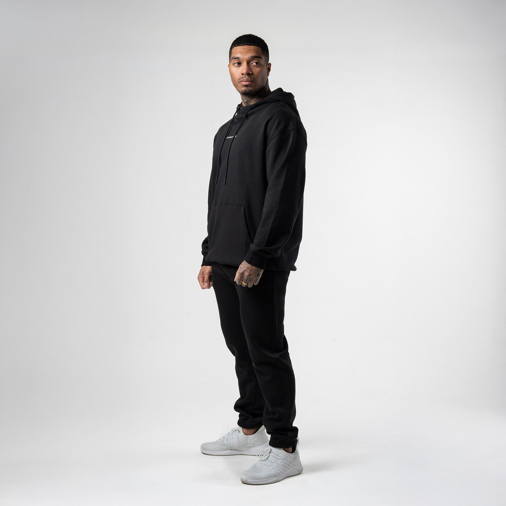 athlete wearing black/white axis mockneck hoodie full body shot