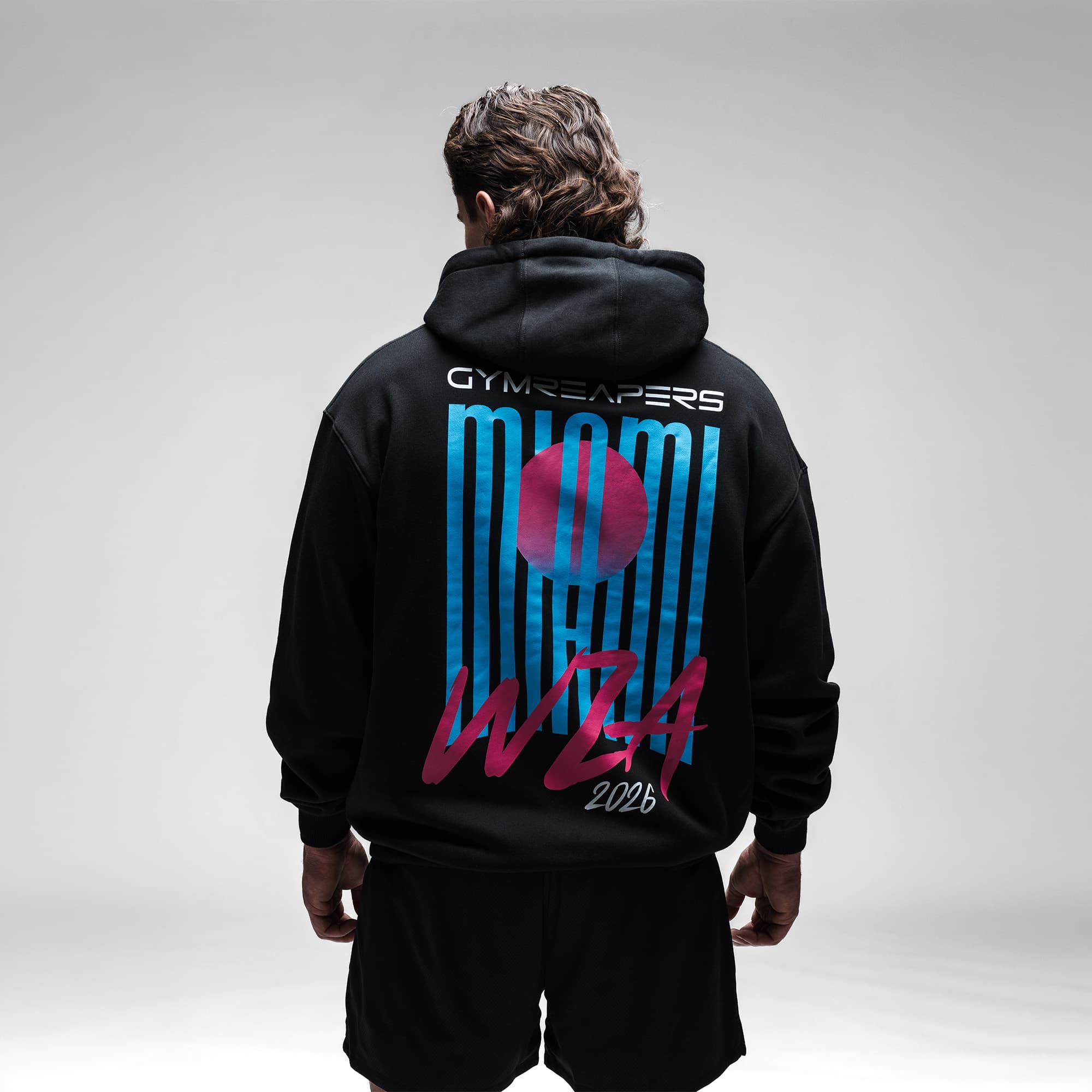 Male athlete wearing the Neon Horizon Hoodie half body shot back view