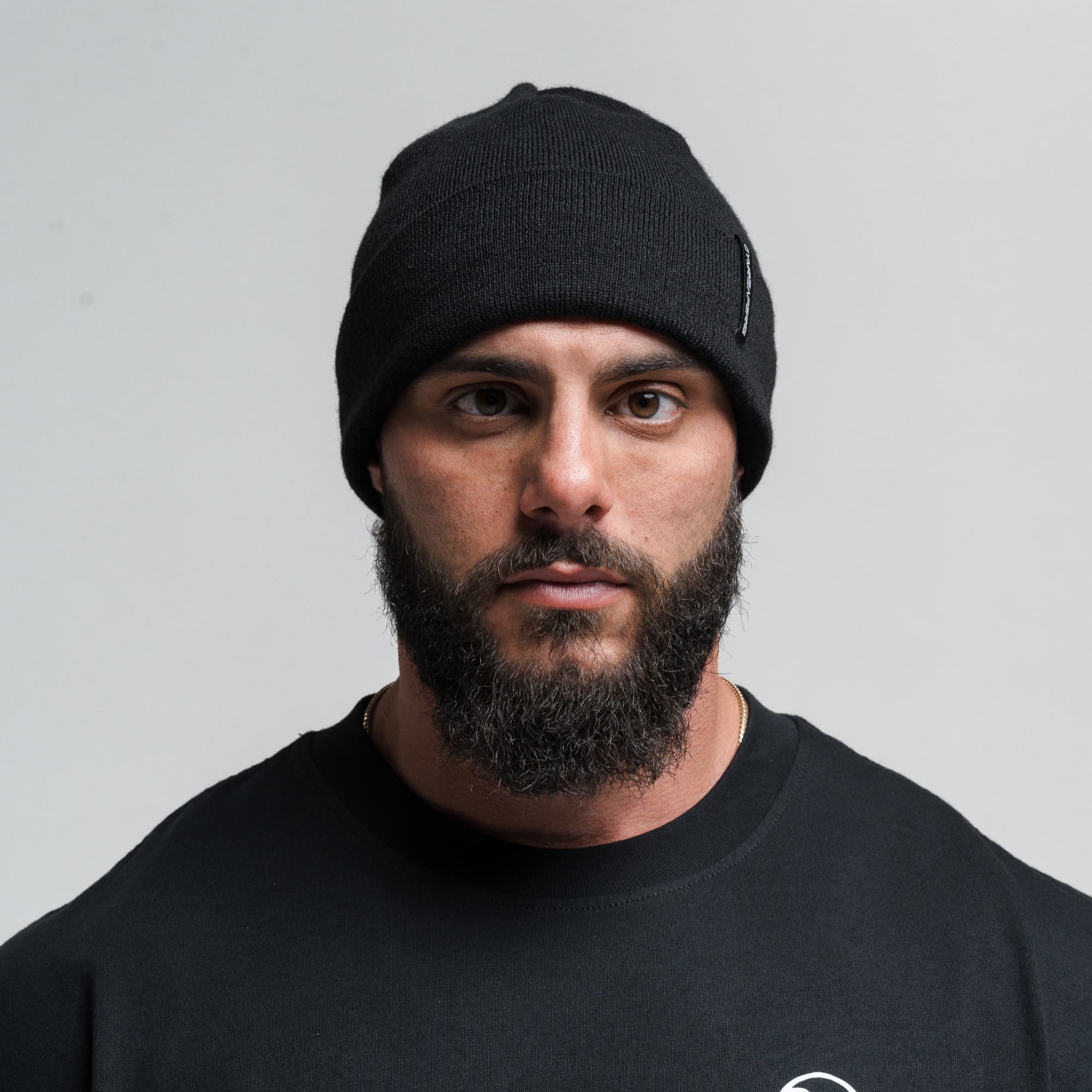 Athlete wearing Core Knit Cuff Beanie - Black front view