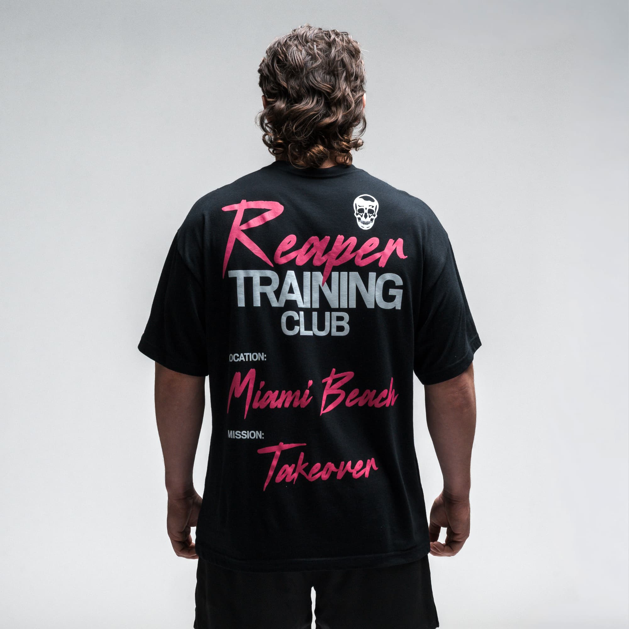 Athlete wearing the Miami Training Club Tee half body shot back view