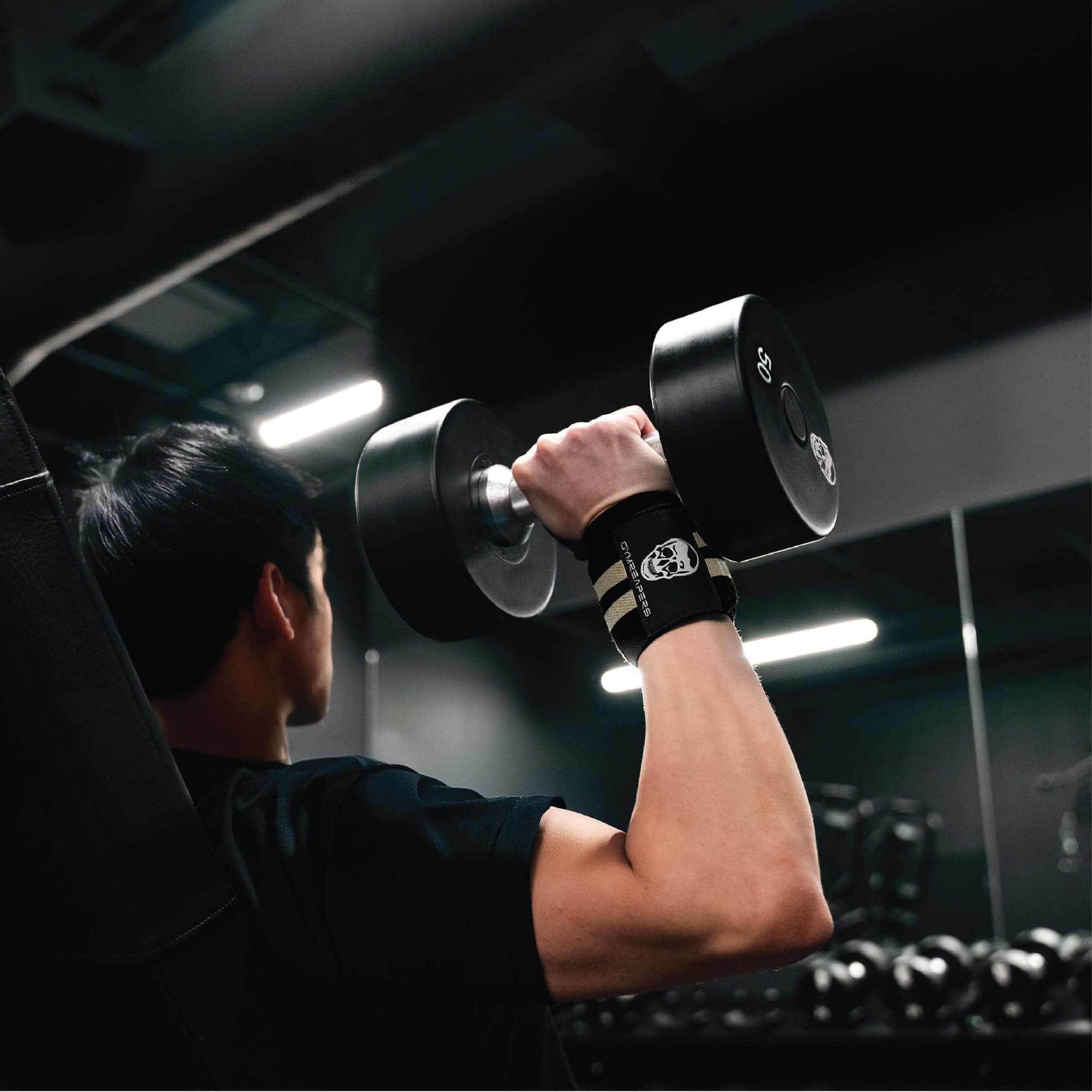 wrist wraps desert sand being used in shoulder press