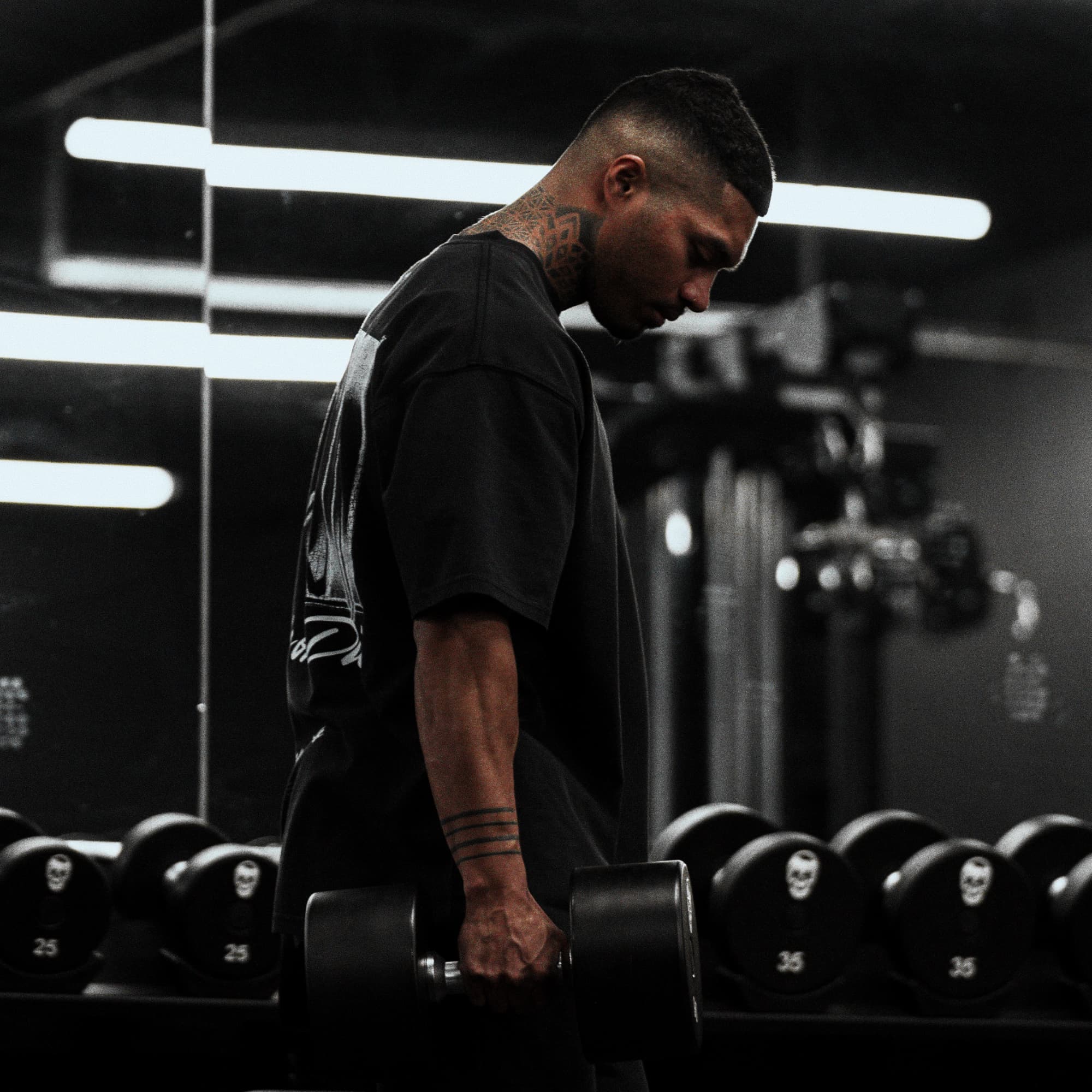 Athlete carrying dumbbells while wearing the 12th Anniversary Tee - Ride or Die