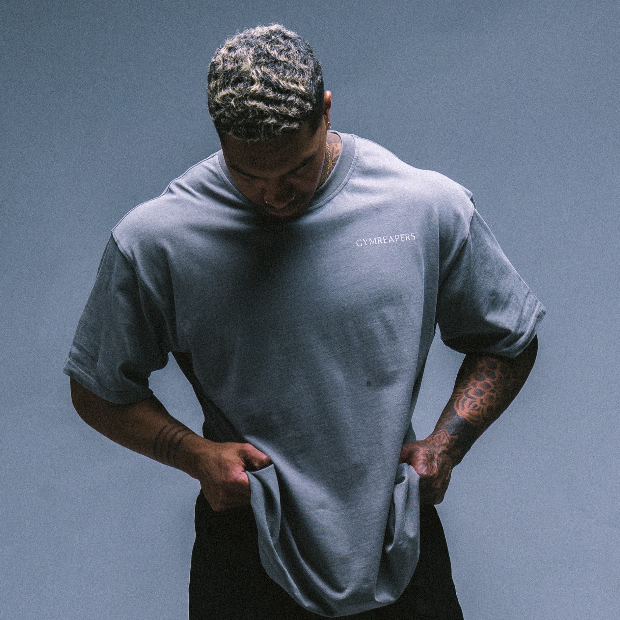 Studio shot of athlete wearing the Reflection Graphic Tee, showing the relaxed fit and soft fabric drape.