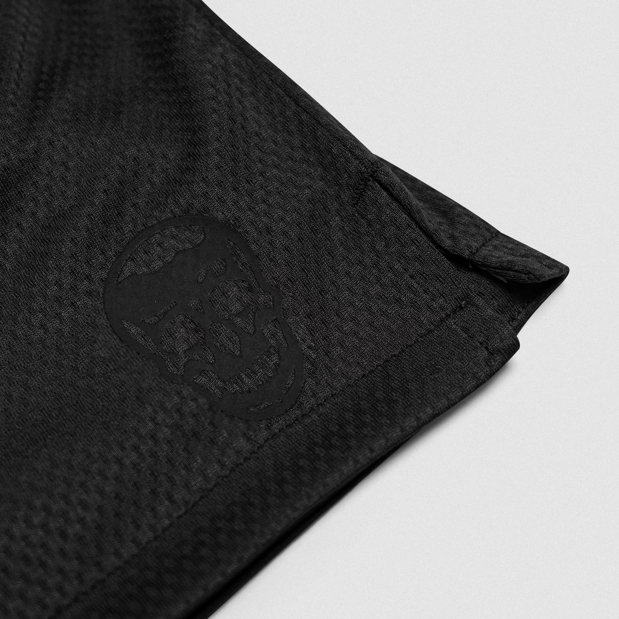 Black/Black Core Skull Mesh Training Shorts lay flat detail shot of logo