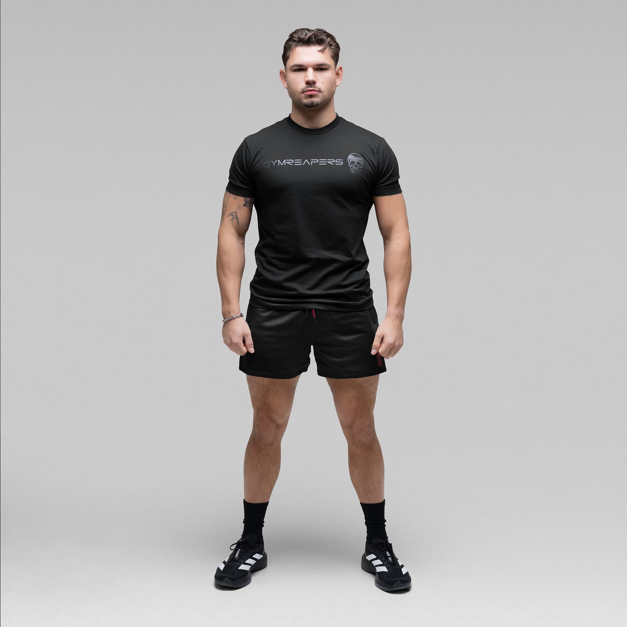 Athlete wearing the Black/Red Core Skull Mesh Training Shorts full body shot