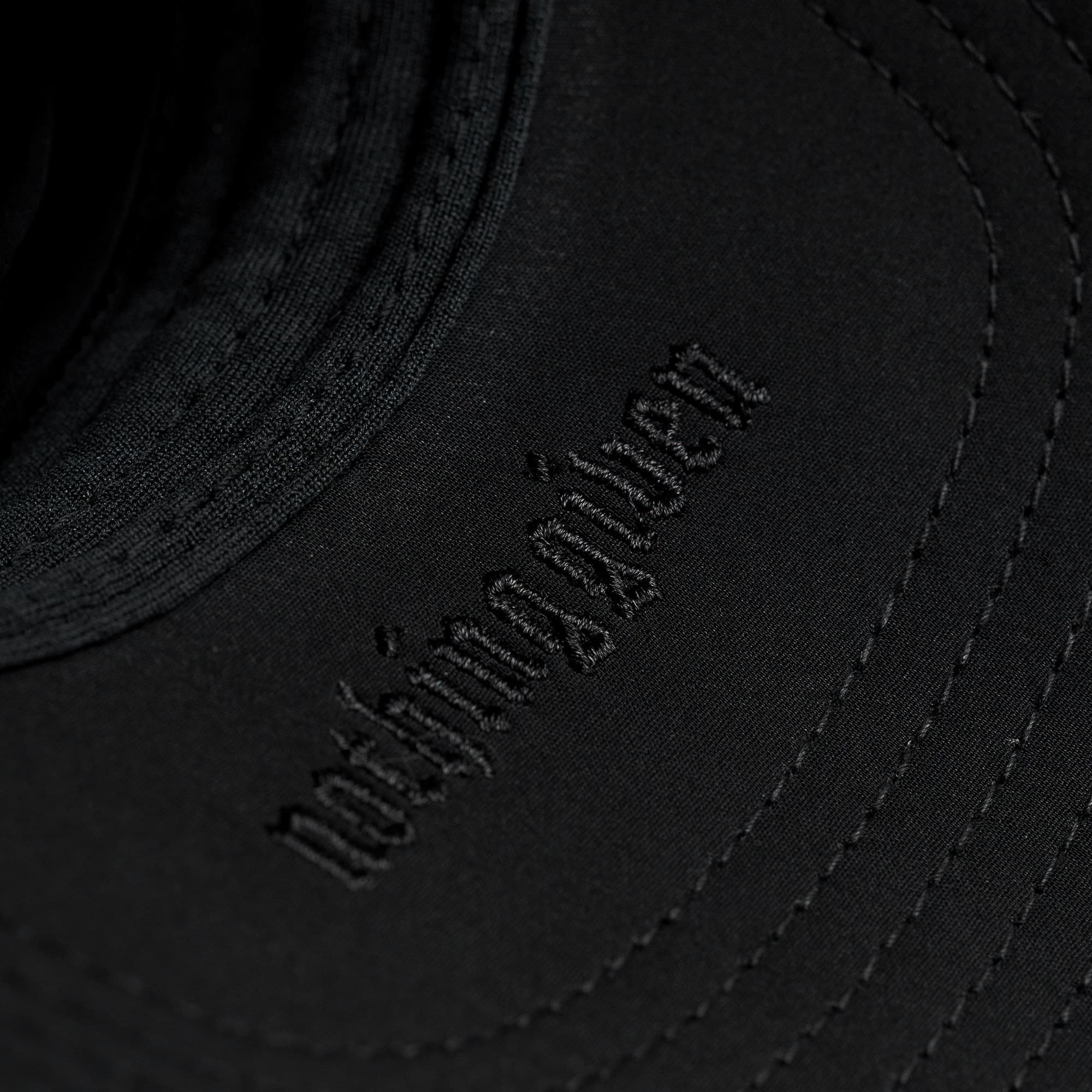 Hybrid Performance 5-Panel Hat - Black/White detail shot of inside logo