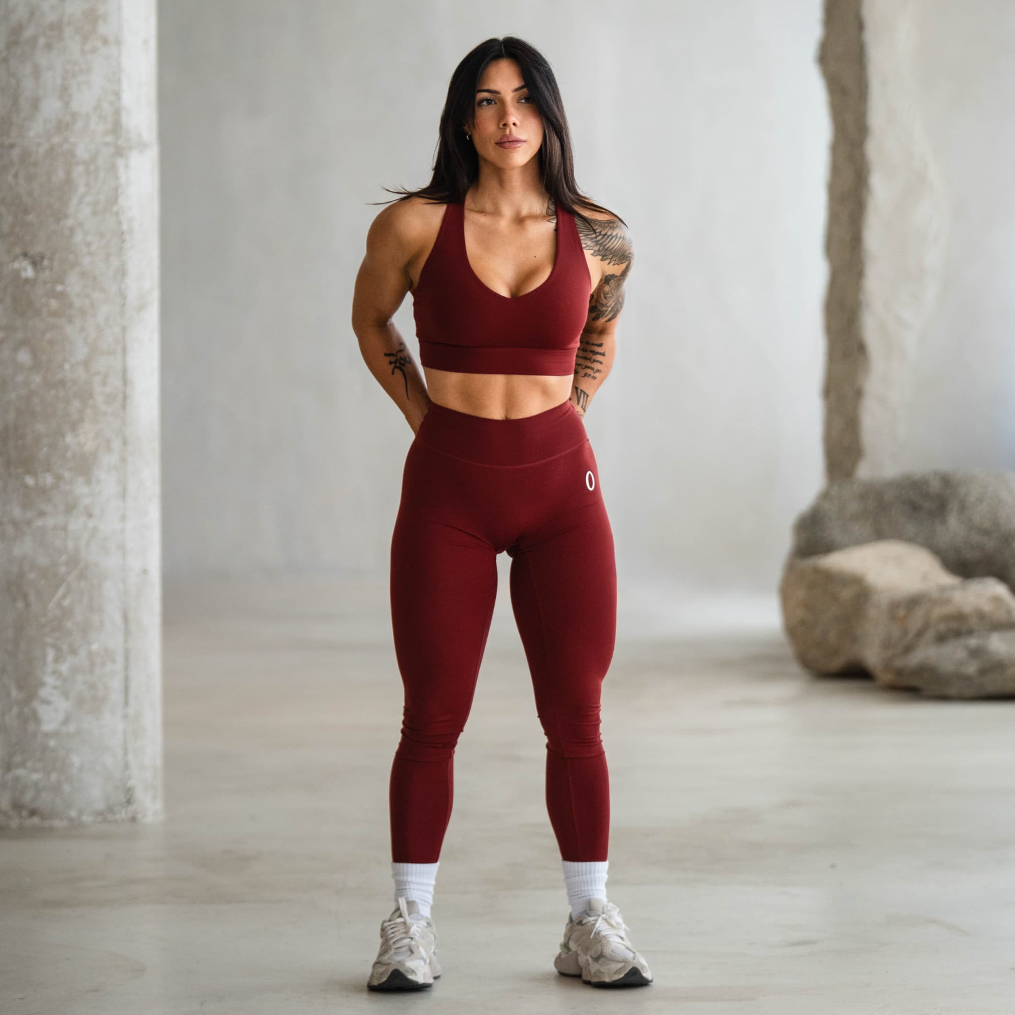 Model standing in the Olympia Harmony Bra and Training Leggings, full front view.