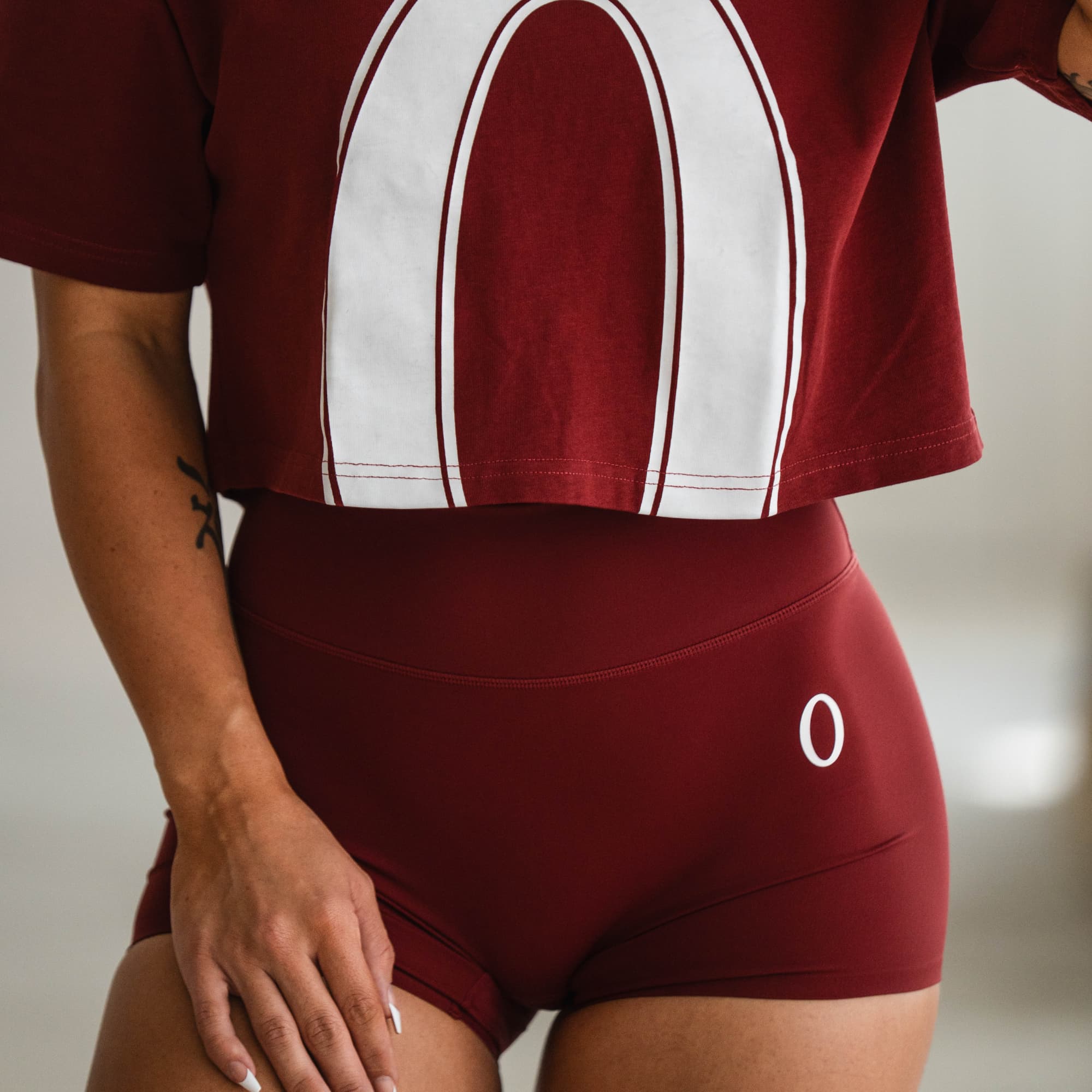 Model styled in Olympia 4" Training Shorts paired with an Olympia cropped tee, front view.