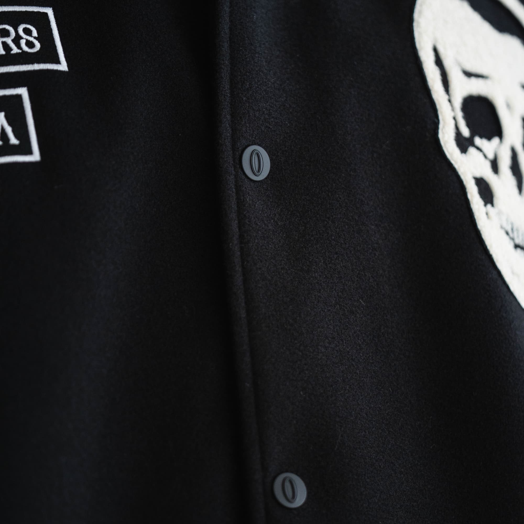 Athlete wearing Electric Skull Jacket close up shot of button details