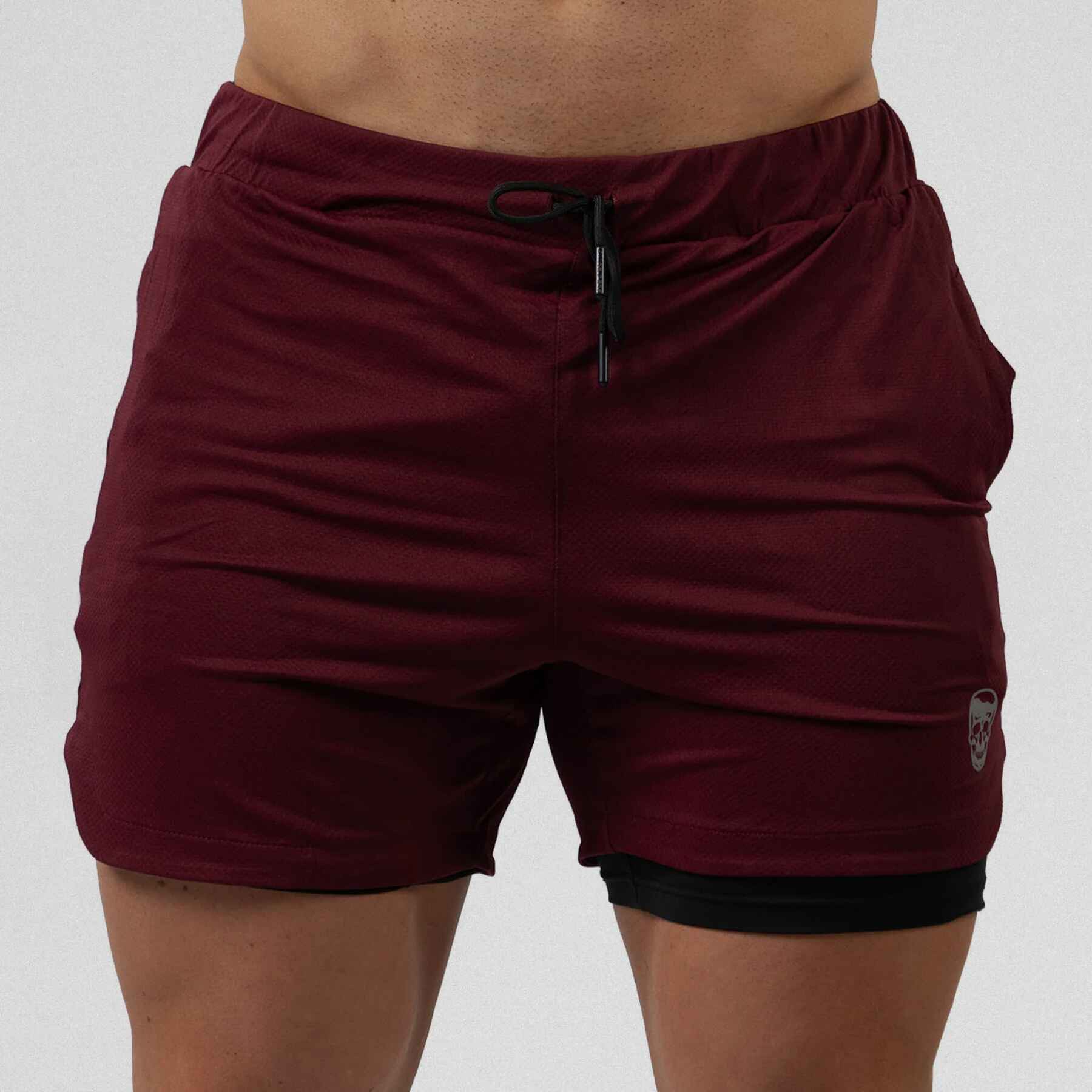 Gymreapers react training shorts maroon color way on athlete showcasing the front.