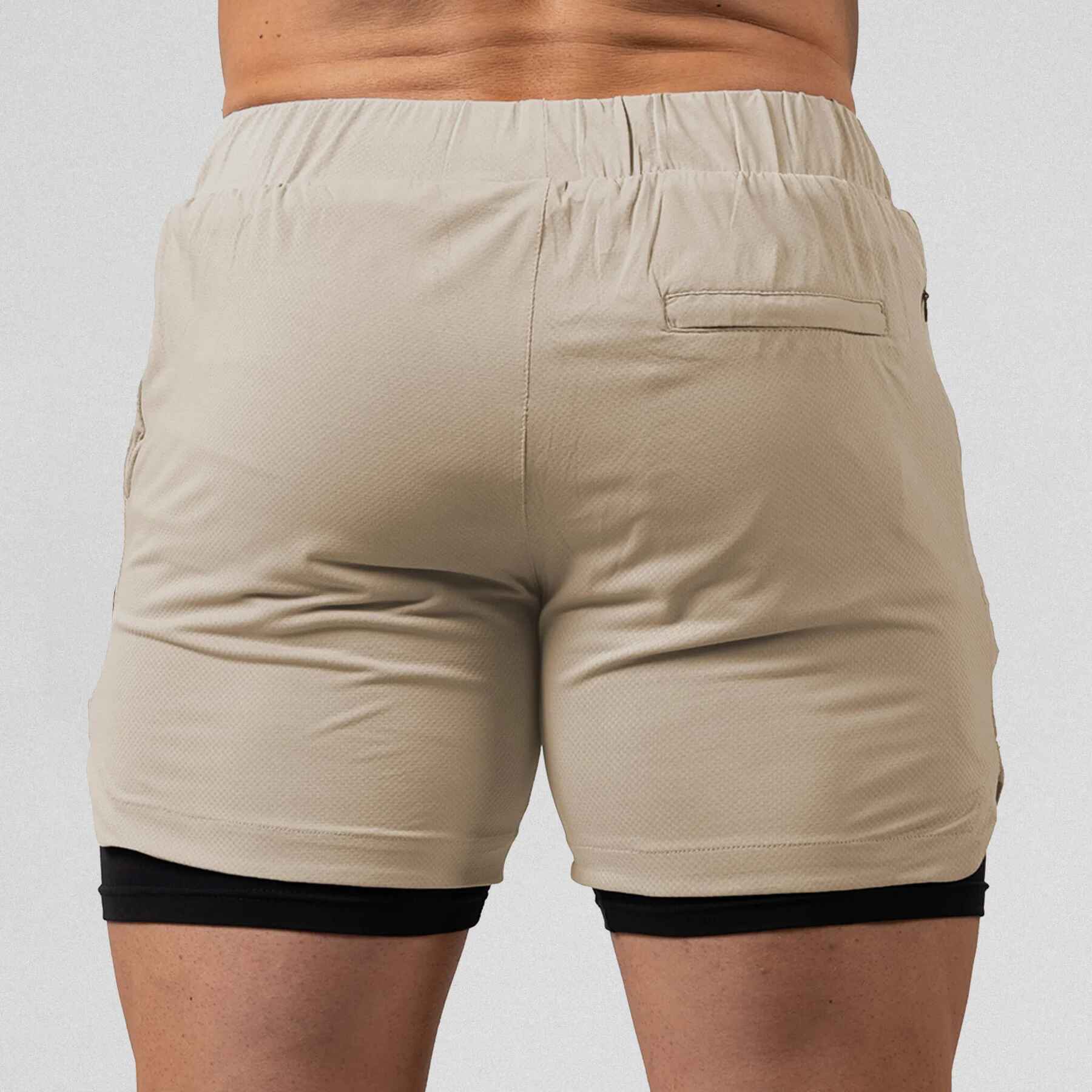 Gymreapers React training shorts tan color way on athlete showcasing the back of the shorts.