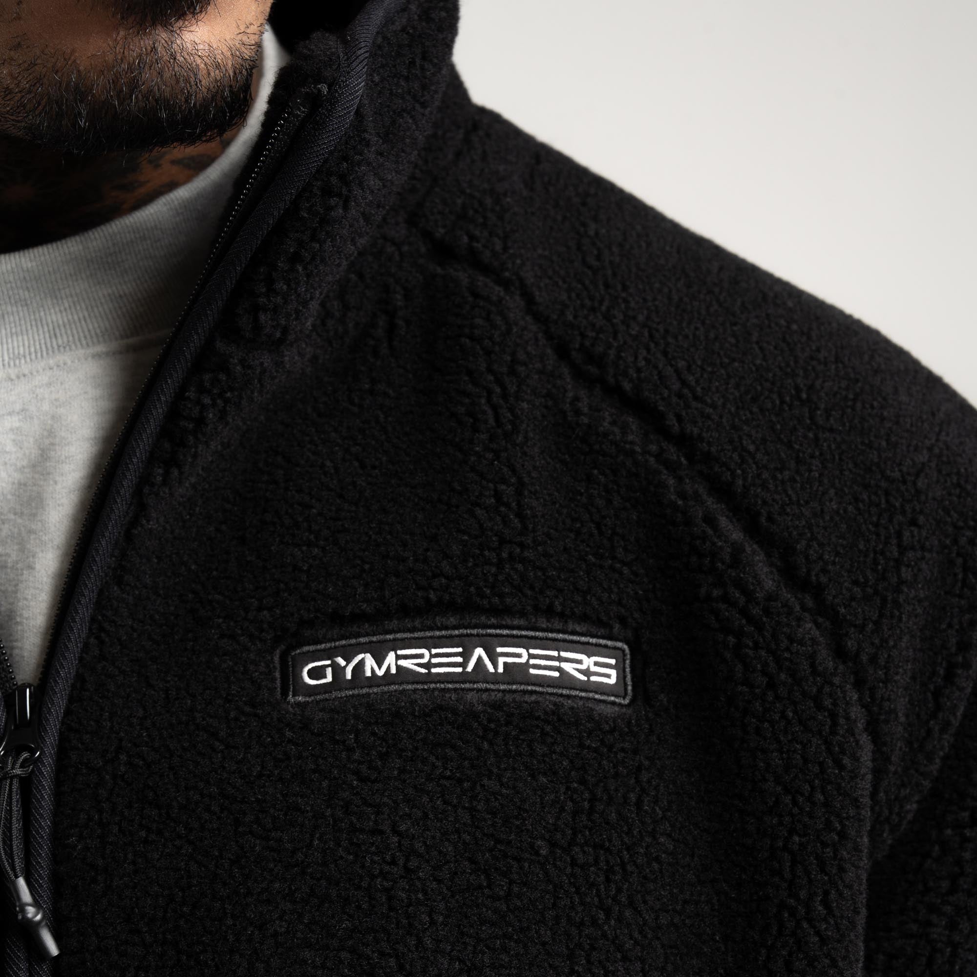 Athlete wearing Sektor Sherpa Jacket close up shot of front logo