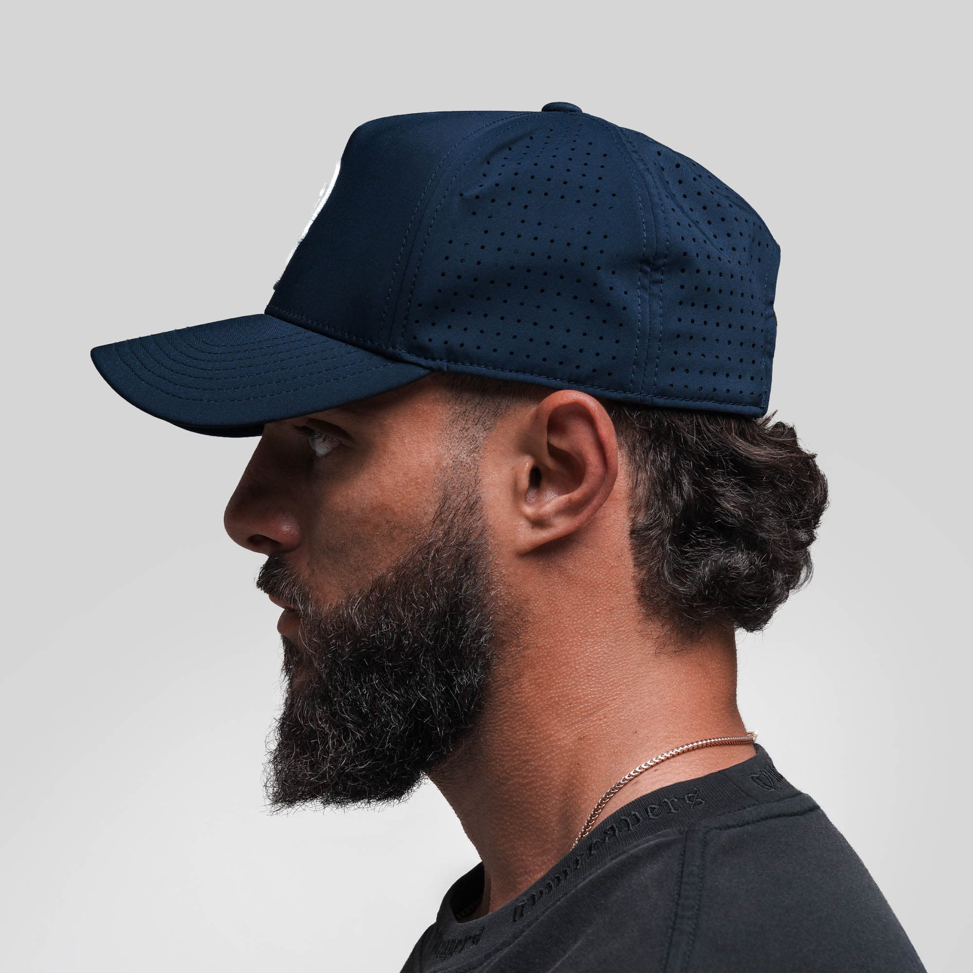 Athlete wearing Hybrid Performance 5-Panel Hat - Navy/White side view