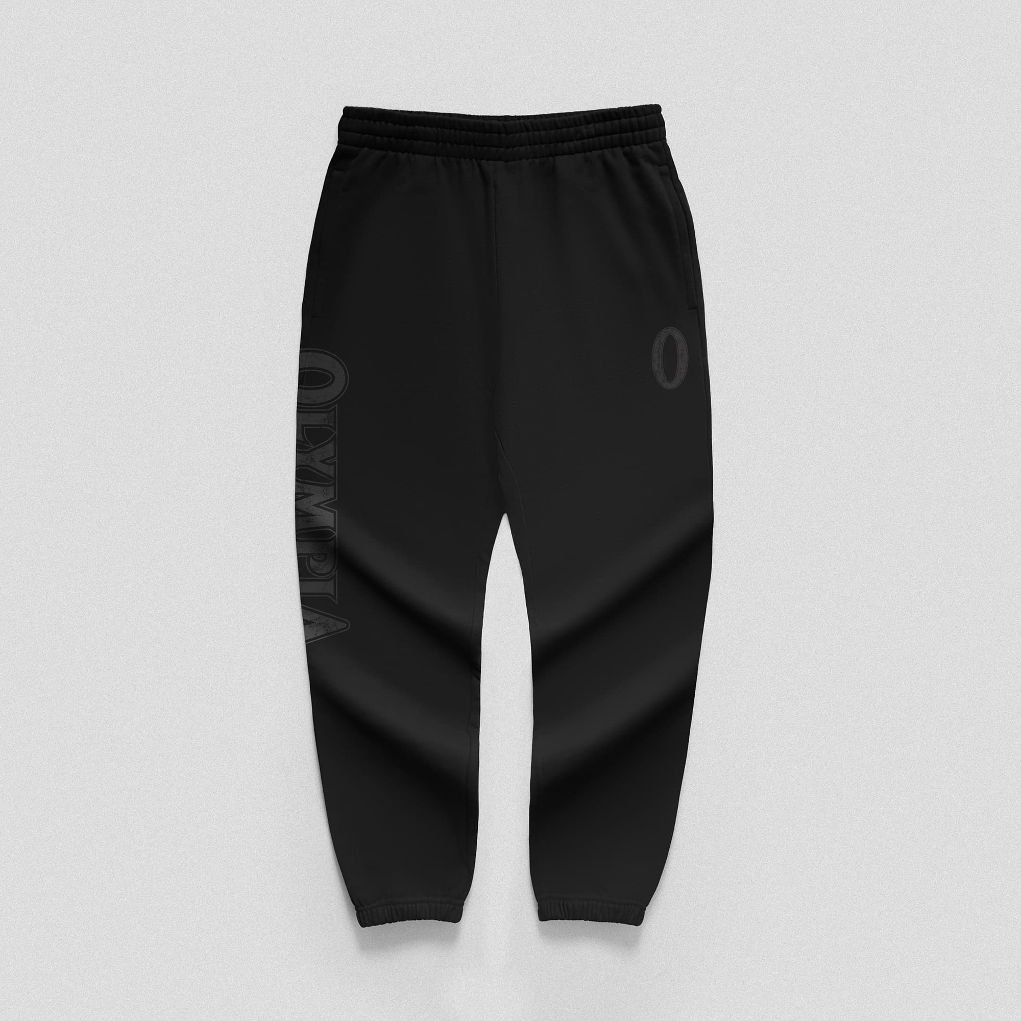 Front view of black Olympia joggers with vertical logo on right leg and “O” logo on hip