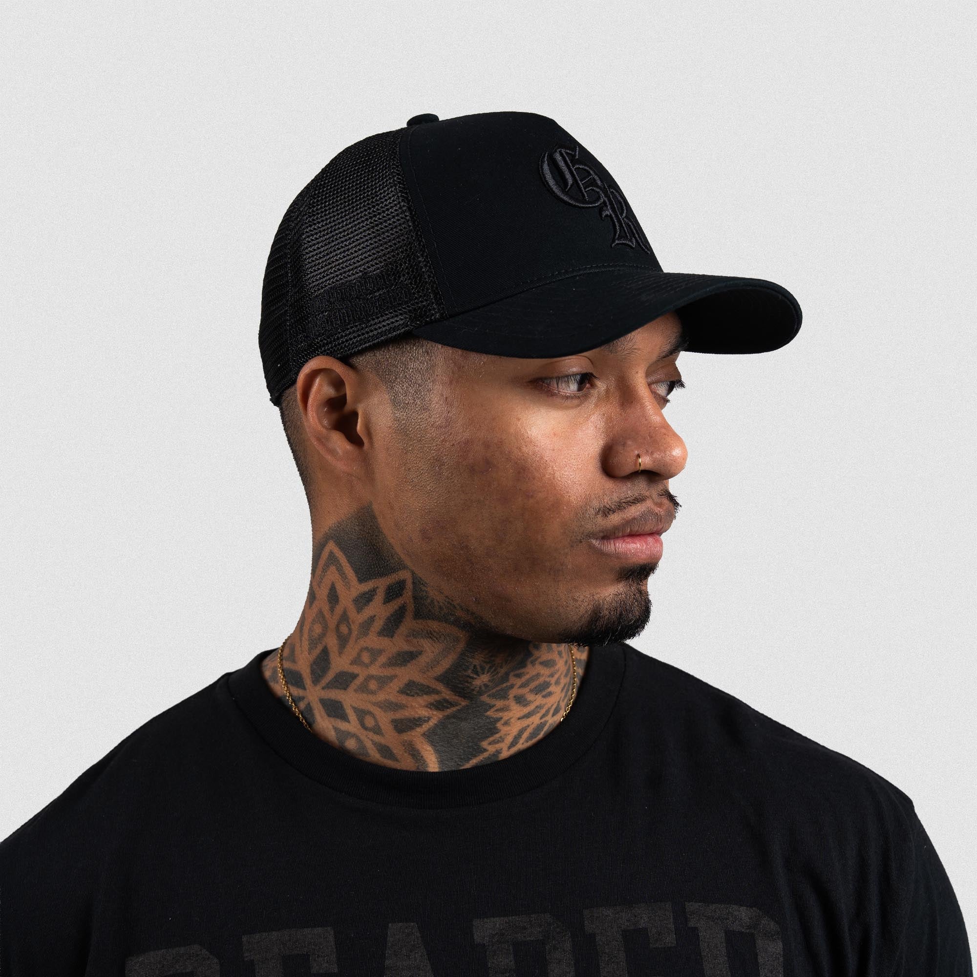 Athlete wearing Black/Black 5-Panel Initial Trucker Hat right side view