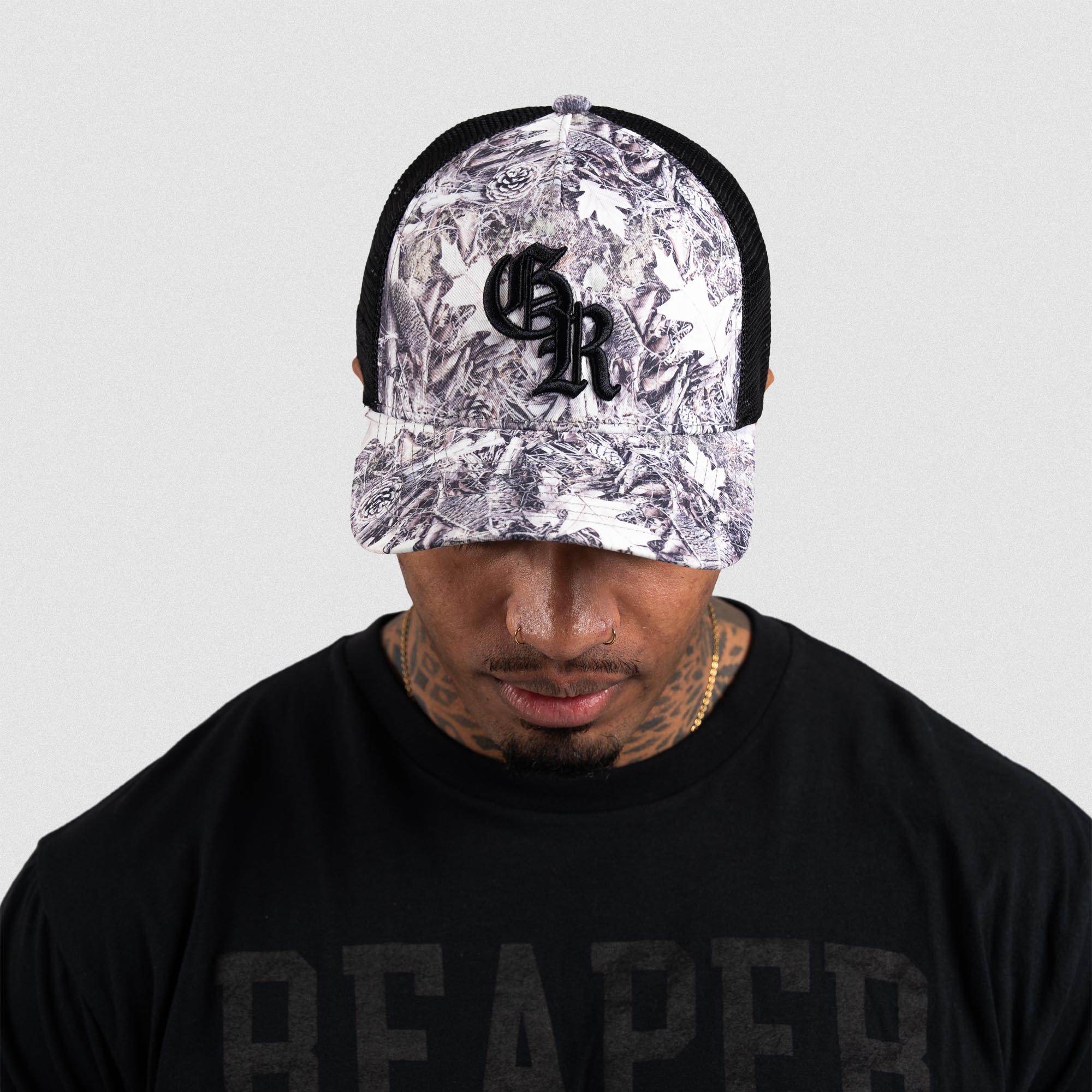 Athlete wearing Camo 5-Panel Initial Trucker Hat front view