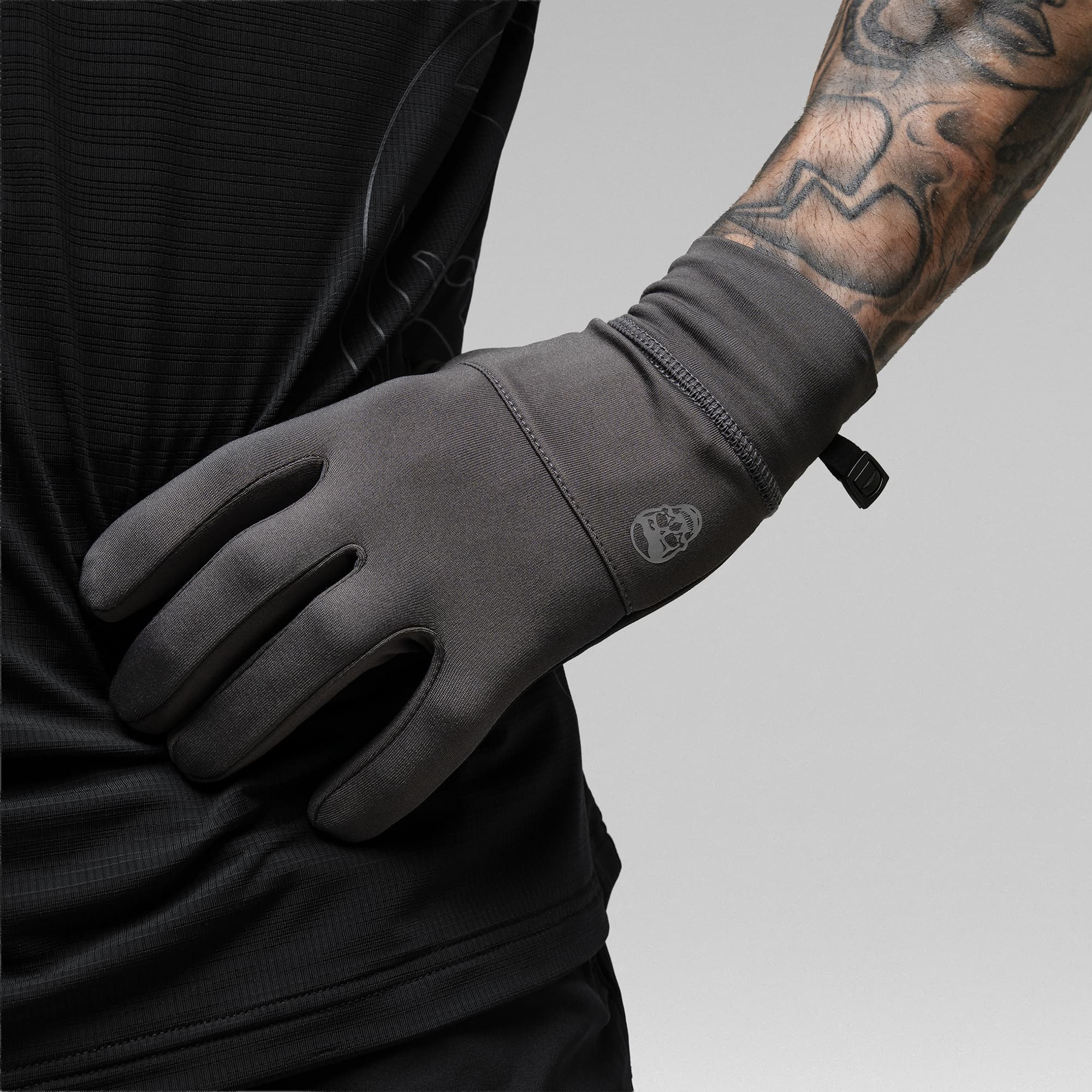 Model wearing the Charcoal Stryda™ Run Gloves with hand on waist