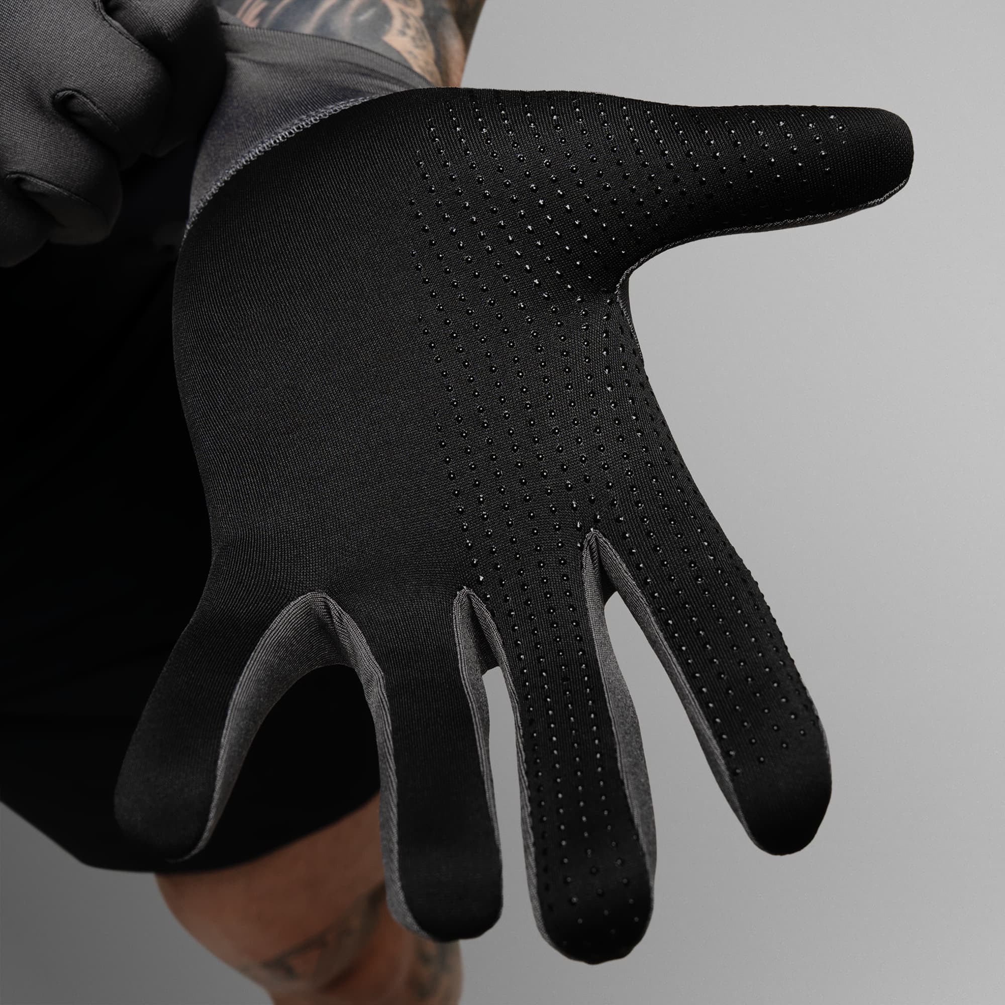Model wearing the Charcoal Stryda™ Run Gloves showcasing the silicone grip