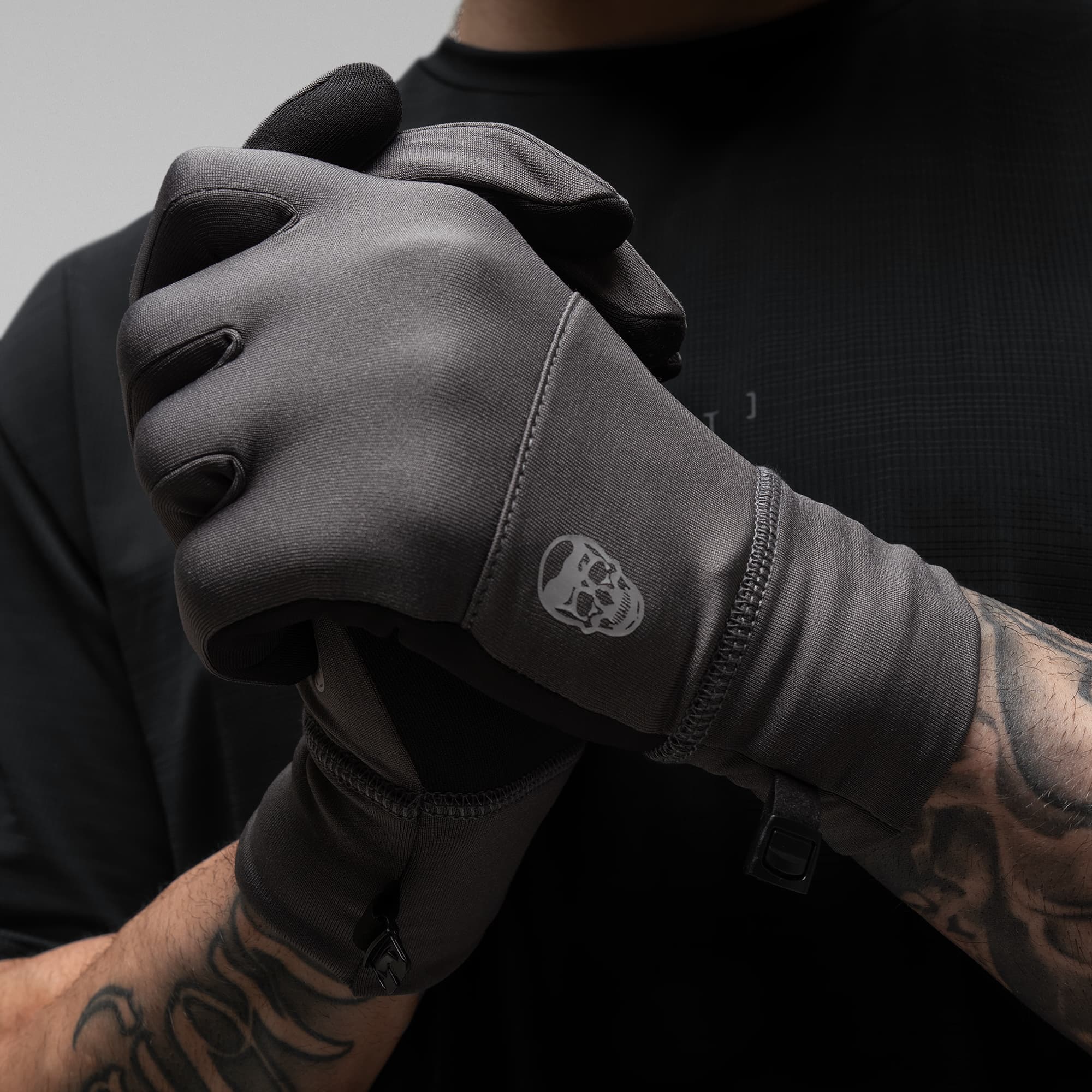 Model wearing the Charcoal Stryda™ Run Gloves showcasing logo