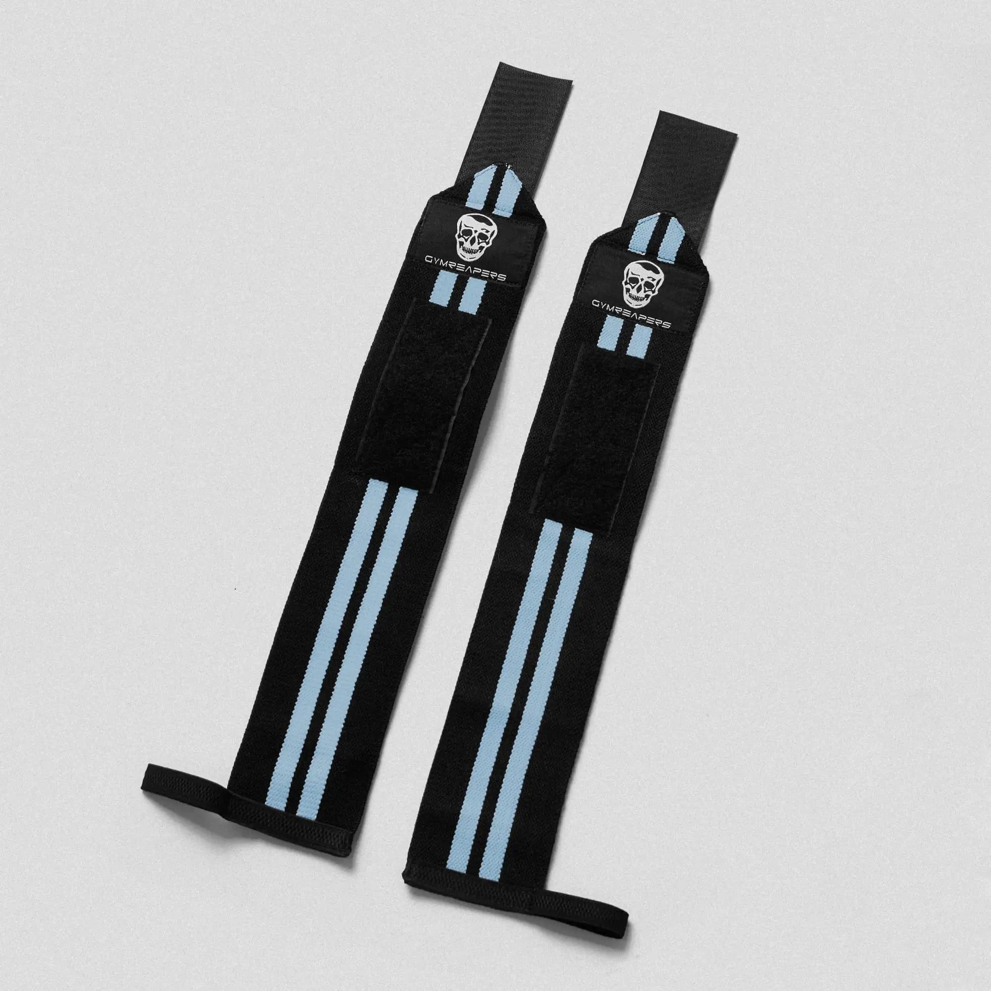 photo of black wrist wraps with blue accents side by side lay flat on gray background