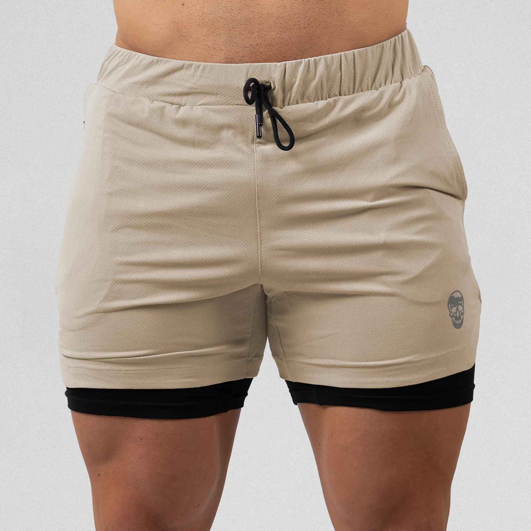 Gymreapers react training shorts tan color way on athlete showcasing the front.